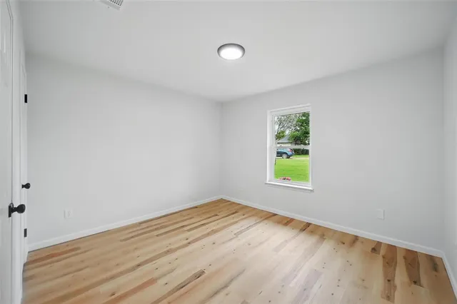 a view of room with window and hardwood floor