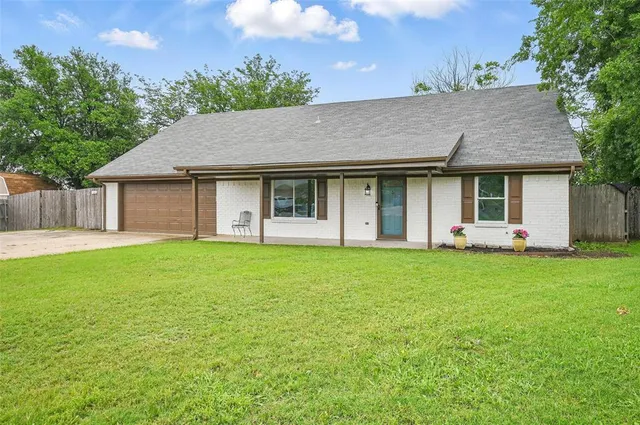 a outdoor view of a house with backyard and garden