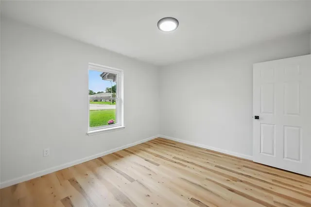 an empty room with a window and flowerpot