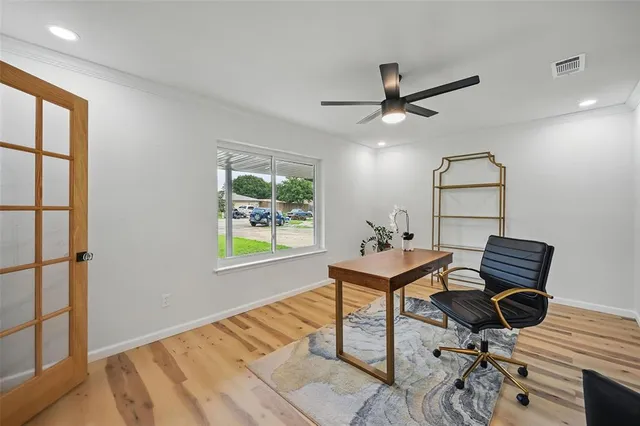a living room with a piano and a window