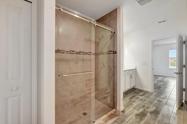 a bathroom with a glass shower door