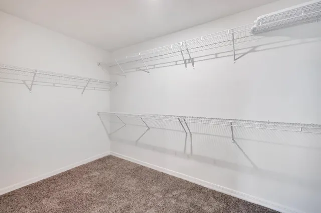 a view of staircase with wooden floor and white walls