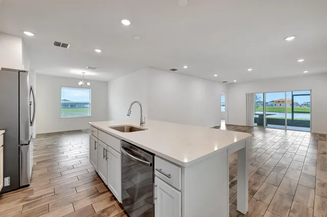 a kitchen with a sink and a refrigerator