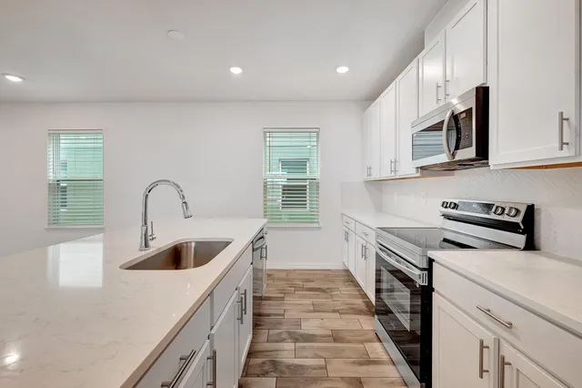 a kitchen with granite countertop a stove and a sink