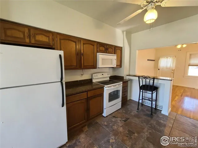 a white refrigerator freezer sitting inside of a kitchen