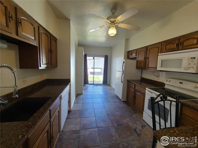 a kitchen with stainless steel appliances granite countertop a sink and a stove top oven