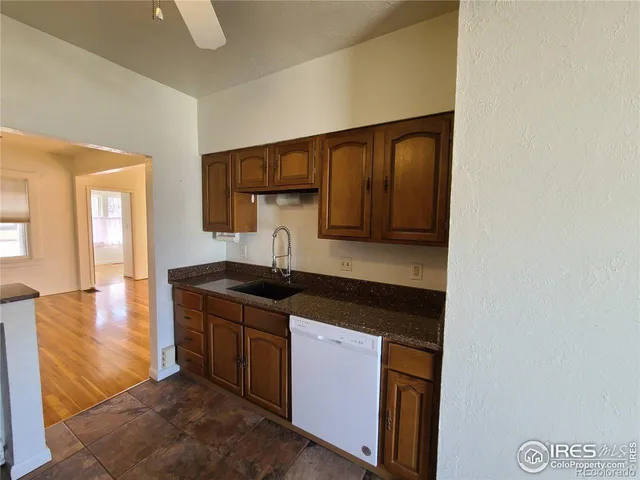 a kitchen with granite countertop a sink and cabinets