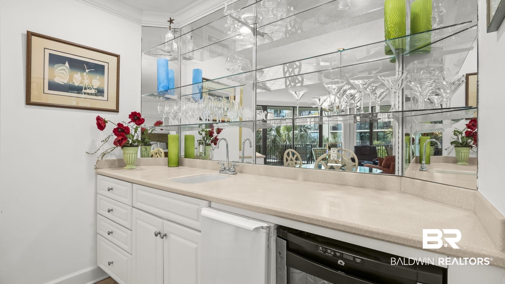 27580 Canal Road, Unit 1213 Orange Beach, AL 36561 - Photo 5 of 27 Wet bar featuring a recessed sink, built-in mini-refrigerator, and mirrored backsplash with glass shelving