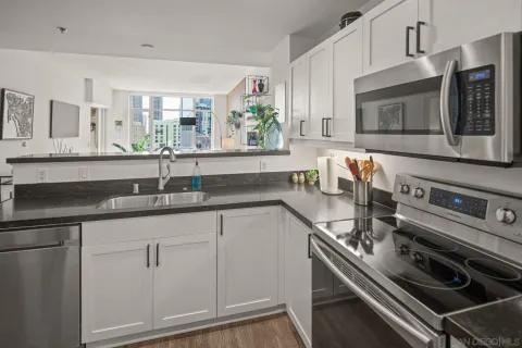 a kitchen with stainless steel appliances granite countertop a refrigerator and a sink