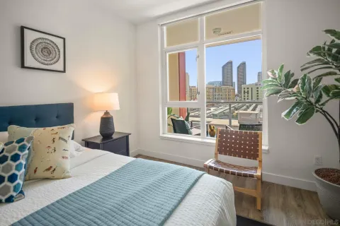 a bathroom with a granite countertop toilet a sink a shower and a mirror