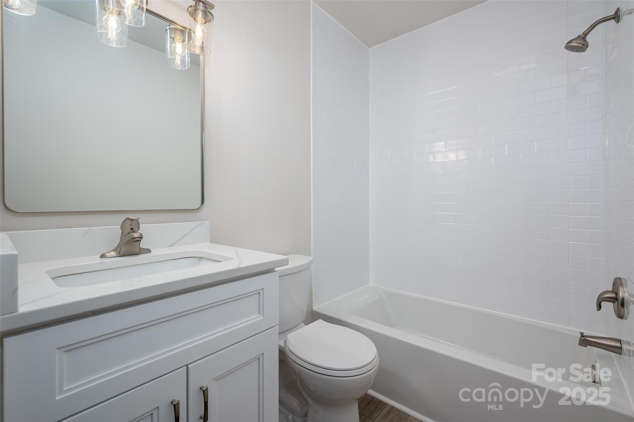 3331 Rock Hill Church Road Concord, NC 28027 - Photo 20 of 46 a bathroom with a sink a toilet and a bathtub