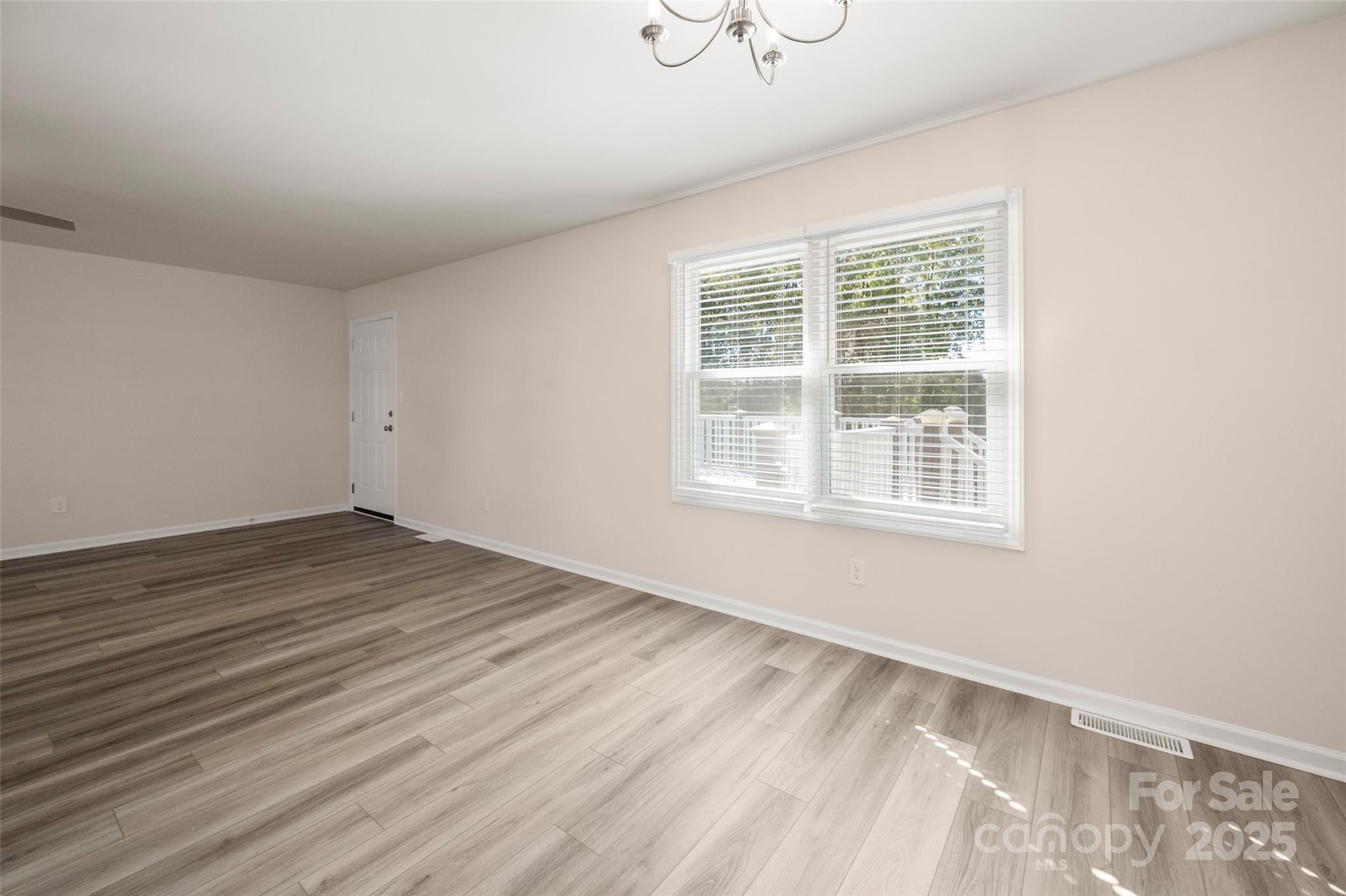 3331 Rock Hill Church Road Concord, NC 28027 - Photo 21 of 46 an empty room with wooden floor and windows