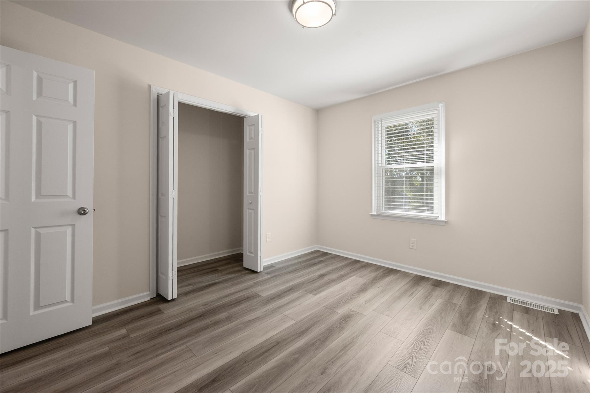 3331 Rock Hill Church Road Concord, NC 28027 - Photo 9 of 46 an empty room with wooden floor and windows