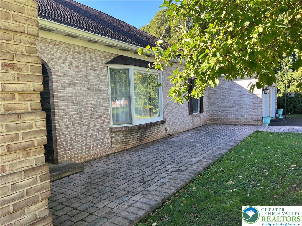 6221 Dove Drive Bethlehem, PA 18017 - Photo 4 of 38 A spacious brick patio borders the exterior of this charming single-level residence.