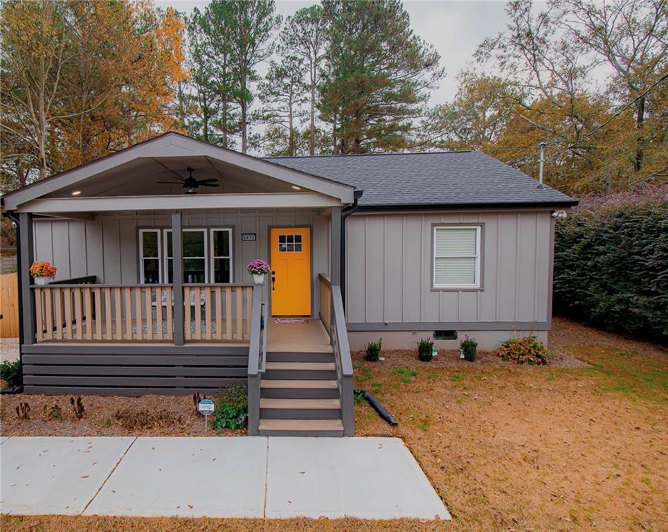 a view of a house with a yard and wooden fence