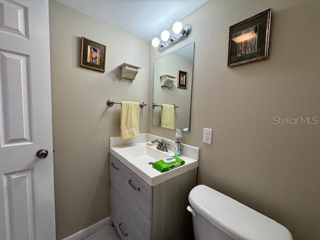 11485 Oakhurst Road, Unit 319 Largo, FL 33774 - Photo 13 of 63 a white toilet sitting next to a bathroom sink