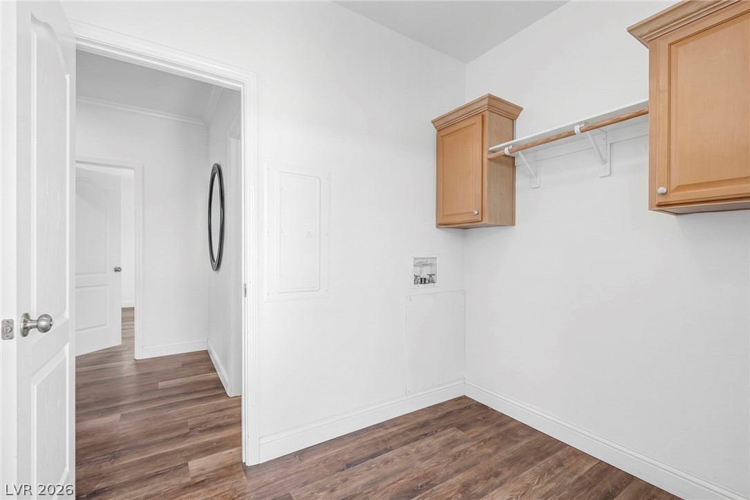 225 California Street Searchlight, NV 89046 - Photo 53 of 64 Functional laundry space featuring ample wood cabinetry and a hanging rod for convenience.