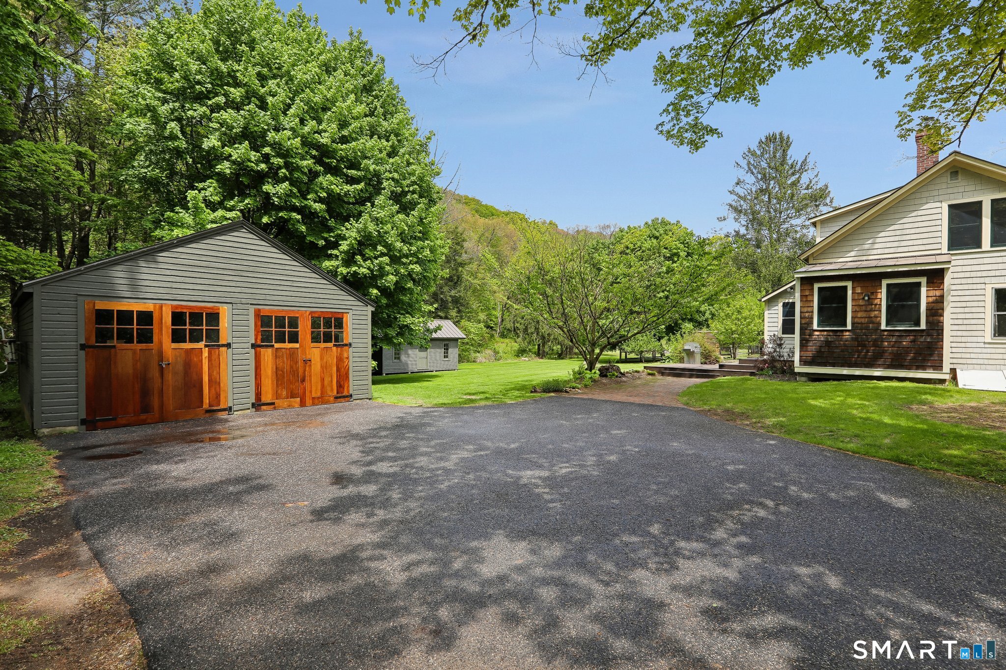 349 Litchfield Road New Milford, CT 06776 - Photo 1 of 27 a front view of a house with a yard and garage