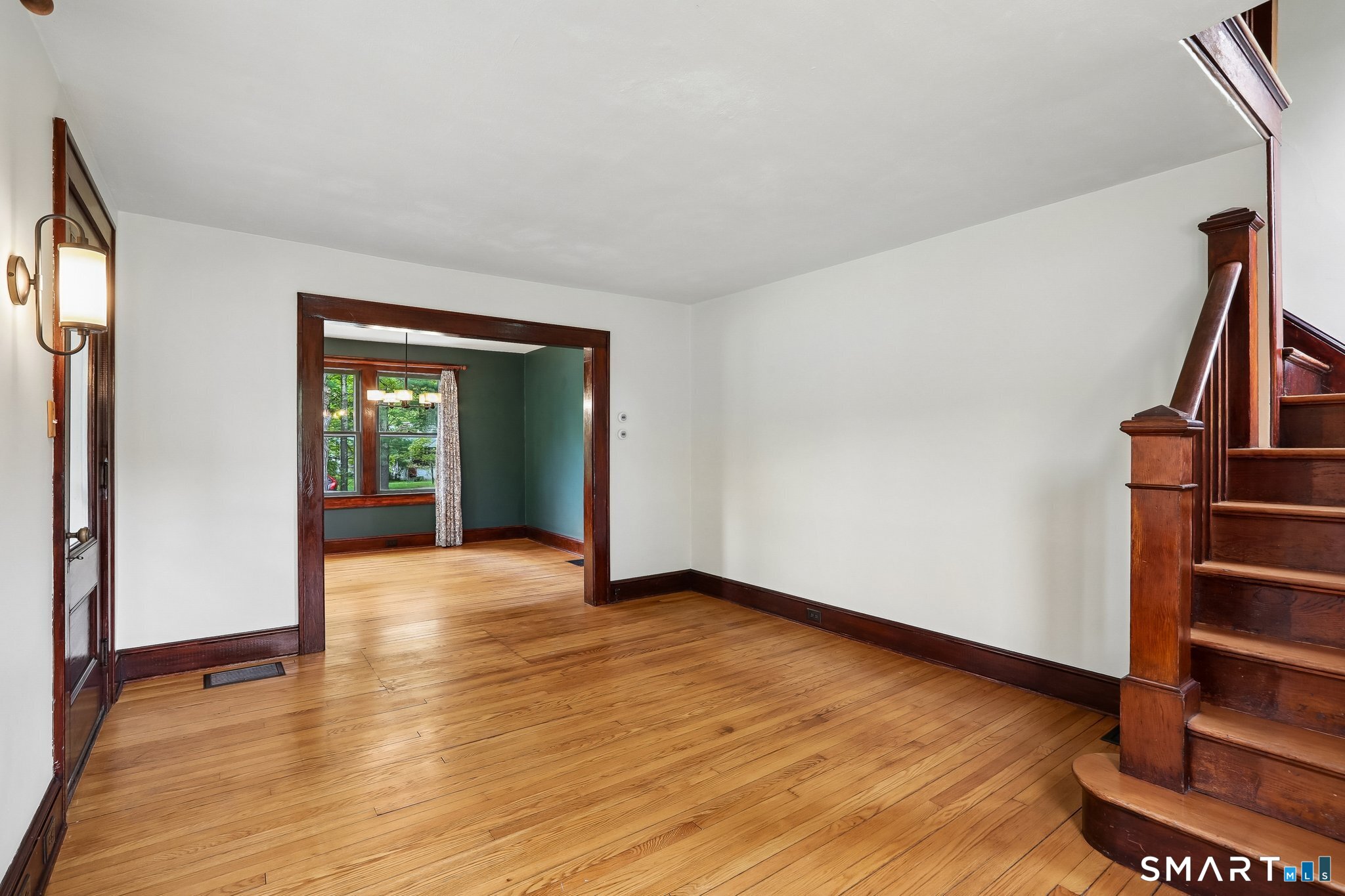 349 Litchfield Road New Milford, CT 06776 - Photo 12 of 27 a view of an empty room with wooden floor and stairs