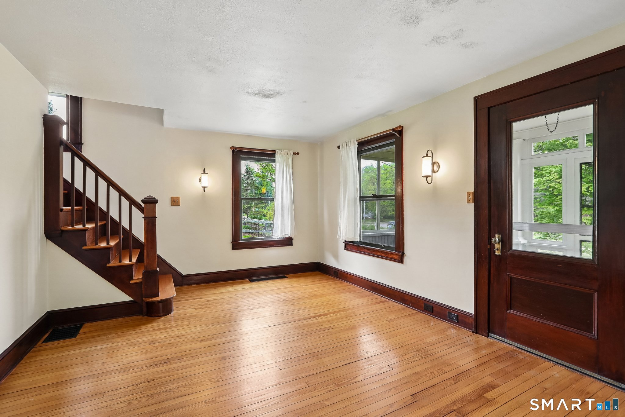 349 Litchfield Road New Milford, CT 06776 - Photo 13 of 27 a view of an empty room with glass door and wooden floor