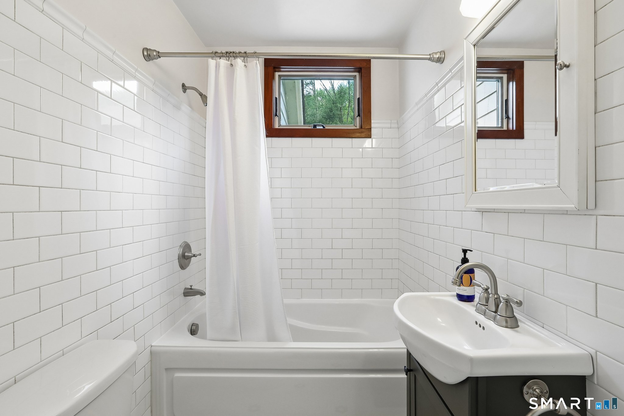 349 Litchfield Road New Milford, CT 06776 - Photo 16 of 27 a bathroom with a sink mirror and a bathtub