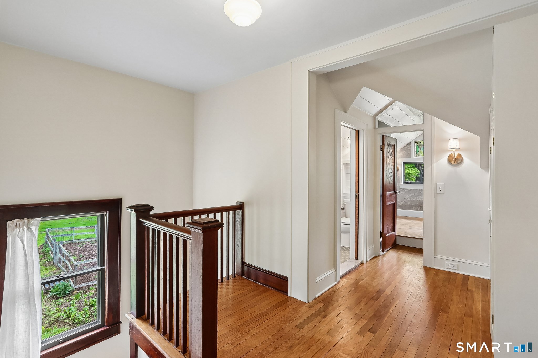 349 Litchfield Road New Milford, CT 06776 - Photo 17 of 27 a view of a hallway with wooden floor and stairs