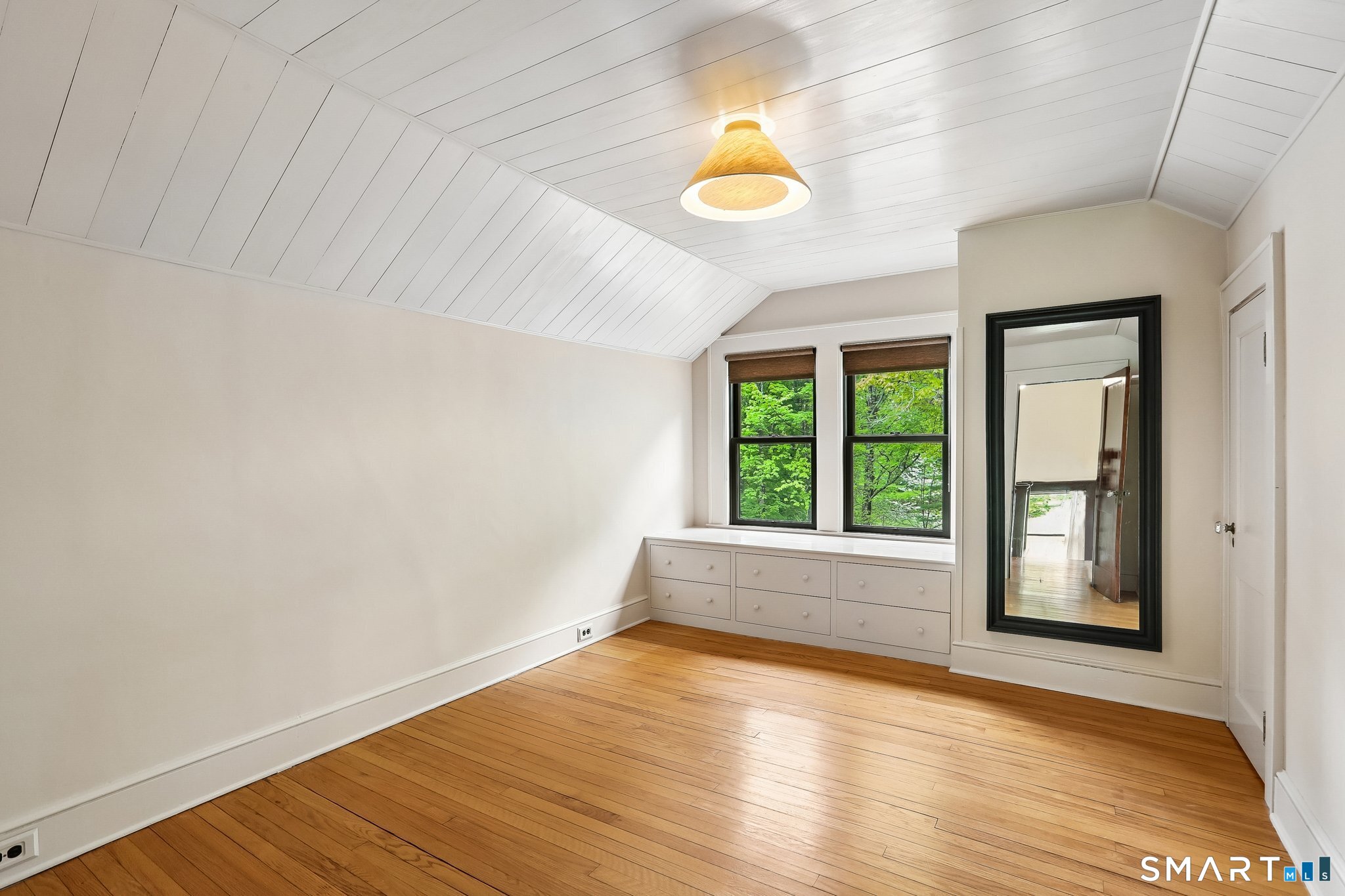 349 Litchfield Road New Milford, CT 06776 - Photo 18 of 27 a view of an empty room with wooden floor and a window
