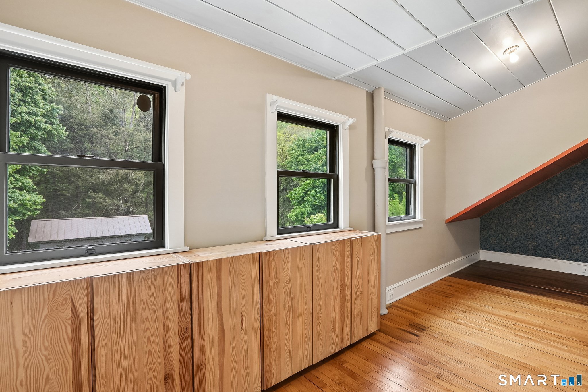 349 Litchfield Road New Milford, CT 06776 - Photo 20 of 27 a view of an empty room with wooden floor and a window