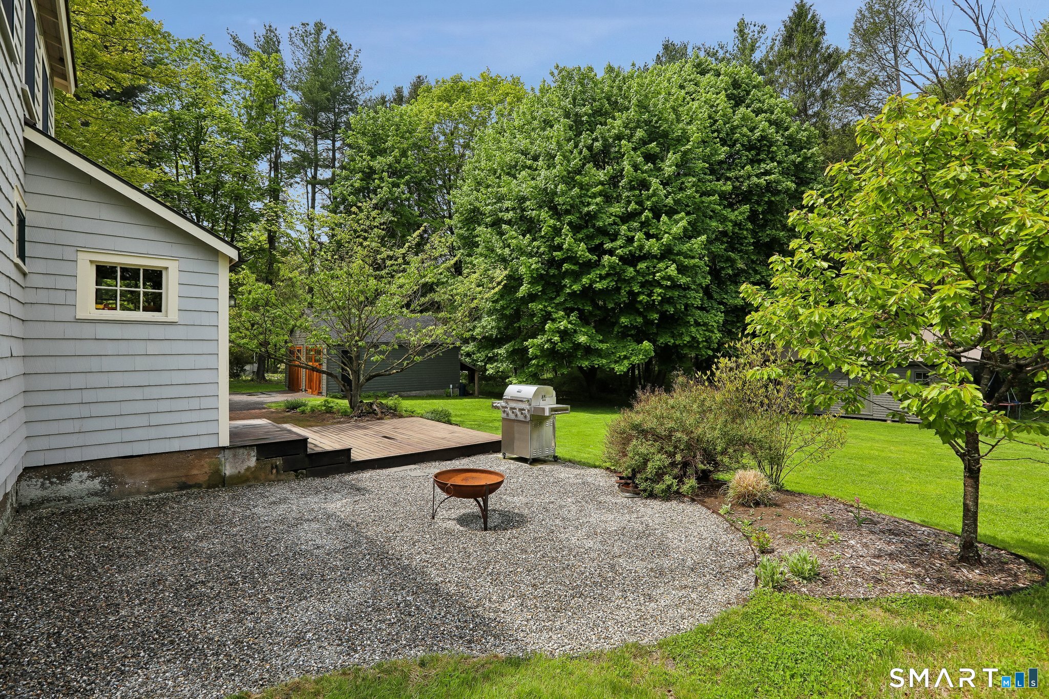 349 Litchfield Road New Milford, CT 06776 - Photo 24 of 27 a backyard of a house with table and chairs