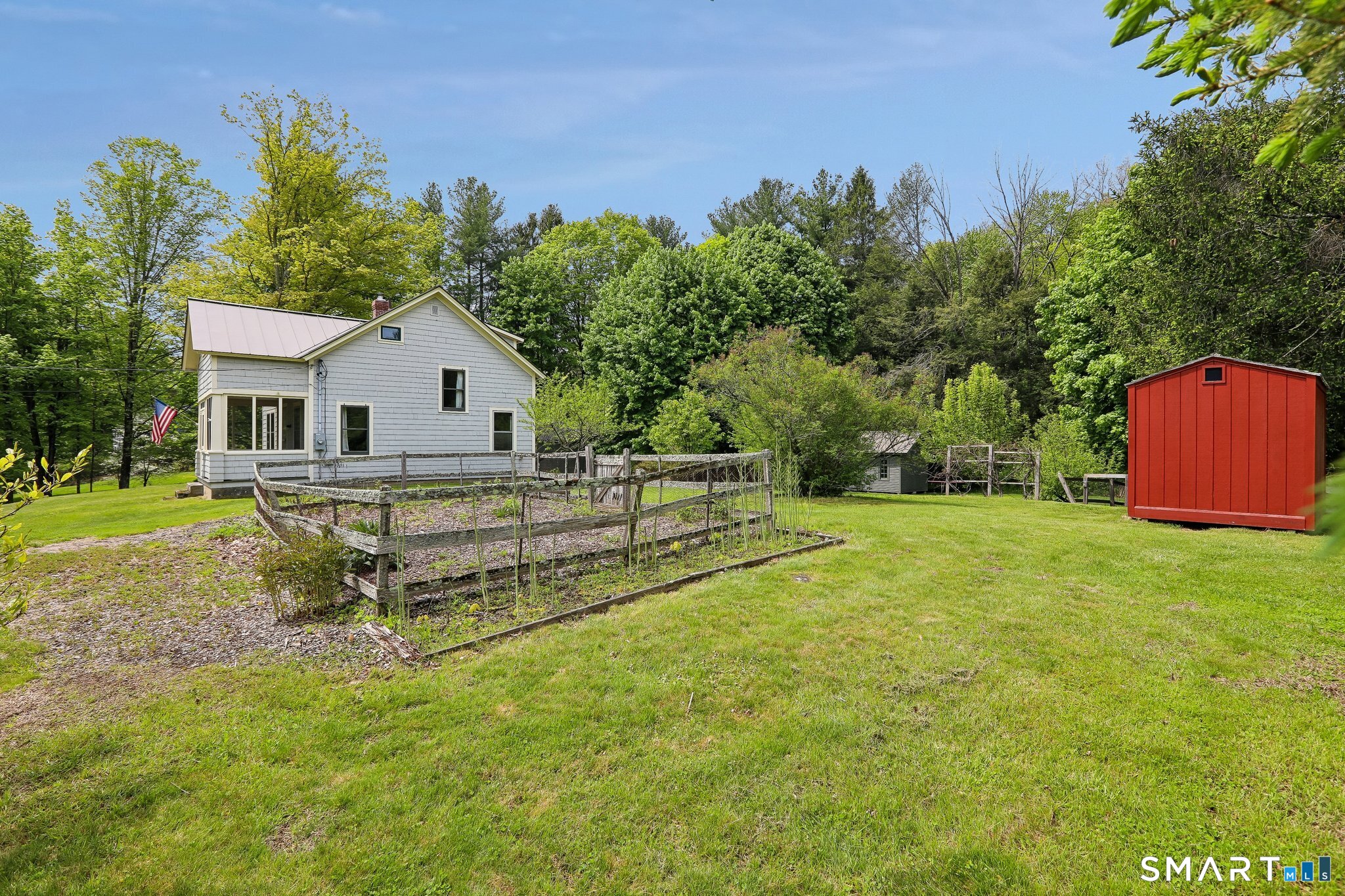349 Litchfield Road New Milford, CT 06776 - Photo 25 of 27 a view of a house with a yard and a garden