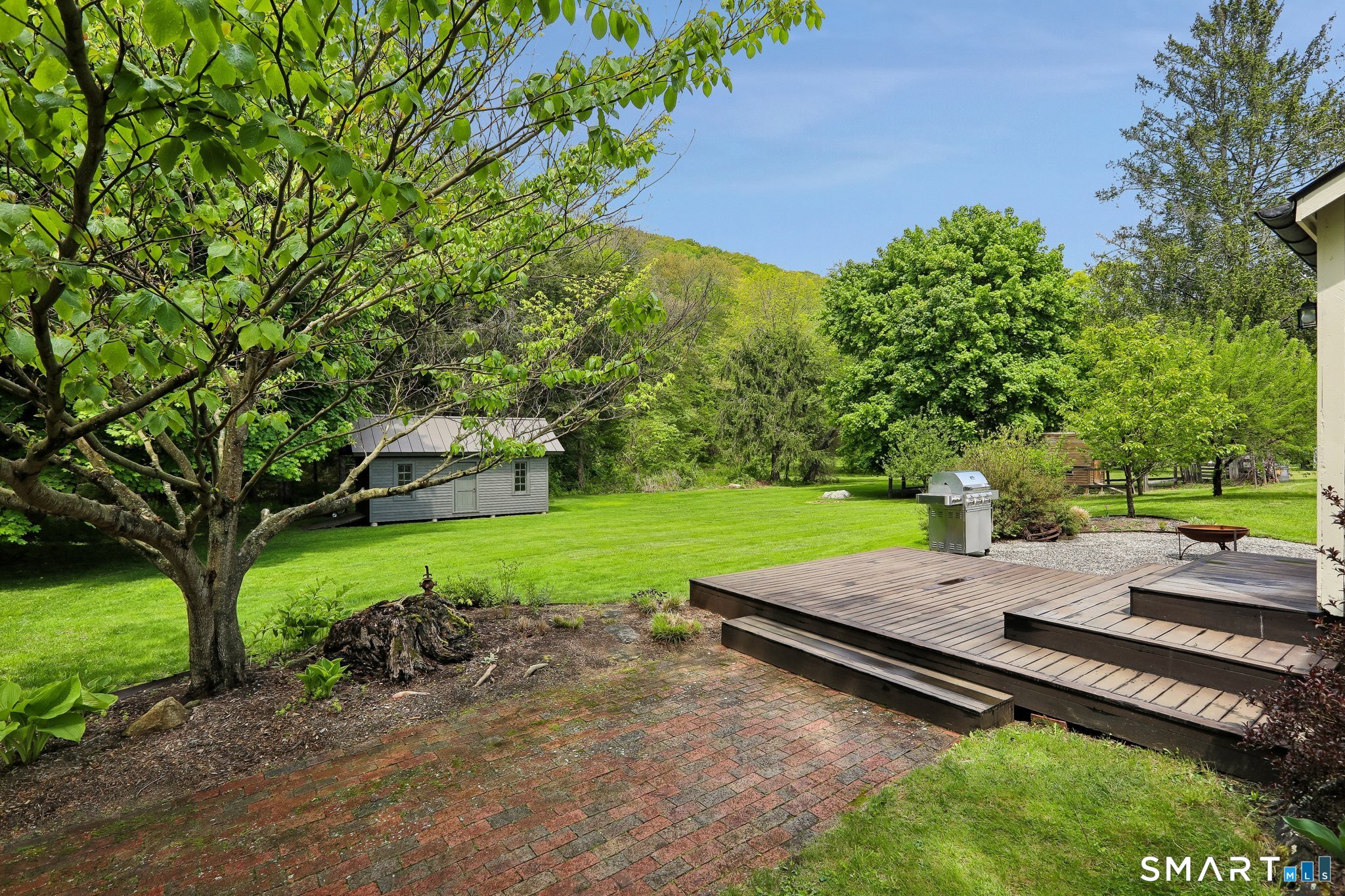 349 Litchfield Road New Milford, CT 06776 - Photo 4 of 27 a view of a backyard with a garden