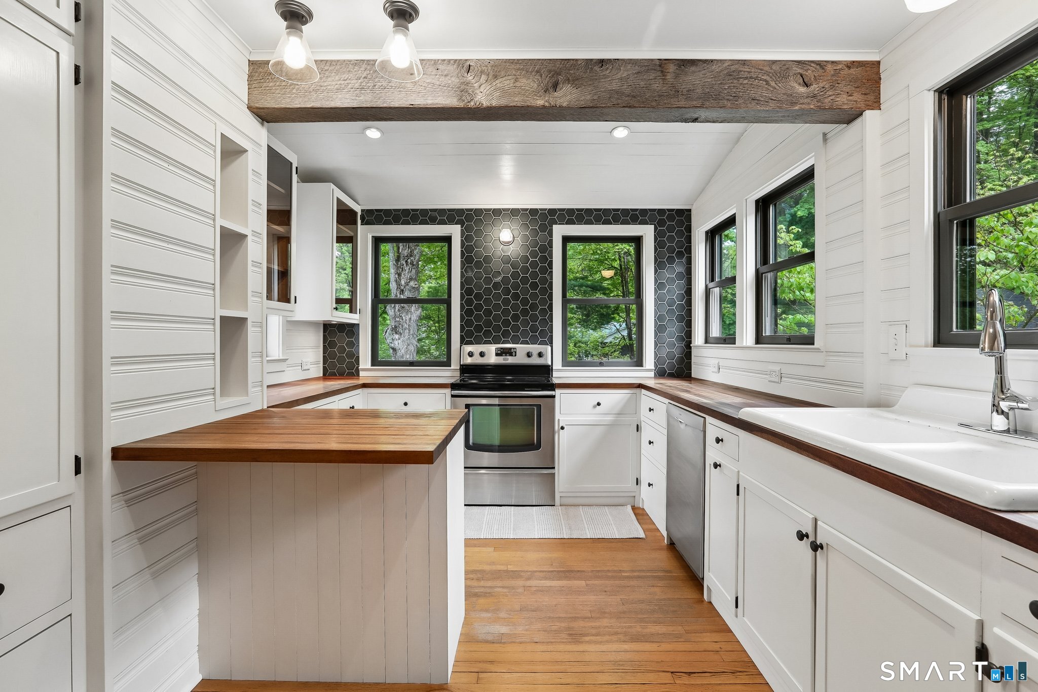 349 Litchfield Road New Milford, CT 06776 - Photo 6 of 27 a kitchen with a sink and large windows