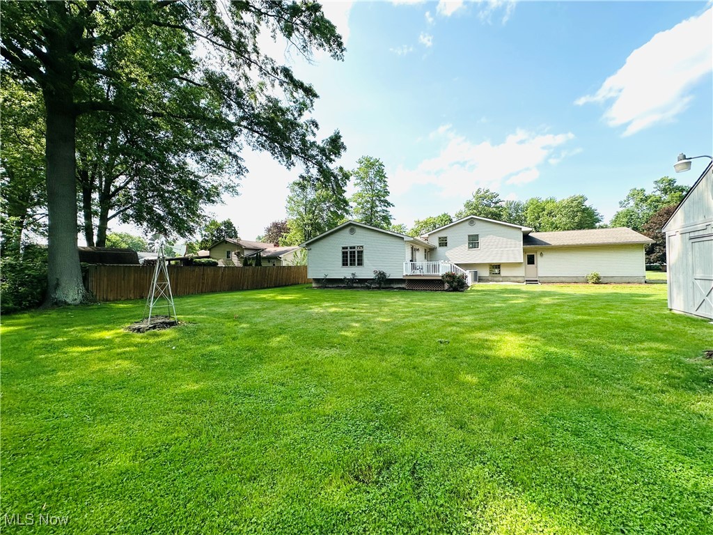 1684 Morris Street Mineral Ridge, OH 44440 - Photo 17 of 50 View of yard with a deck and an outbuilding