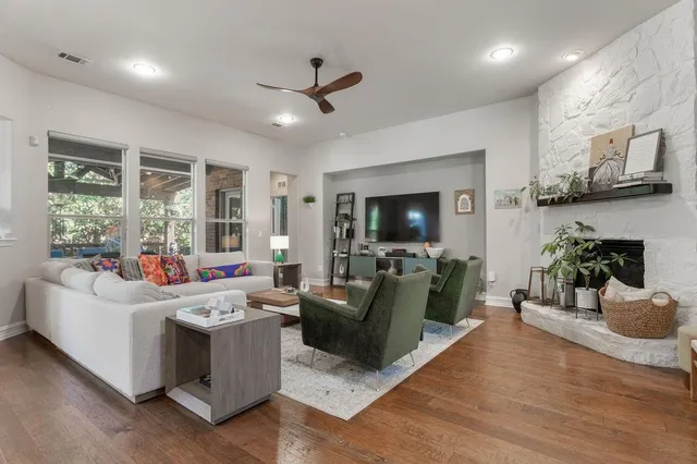 a living room with furniture kitchen view and a chandelier