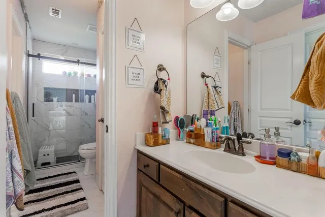 a bathroom with a tub a sink shower and mirror