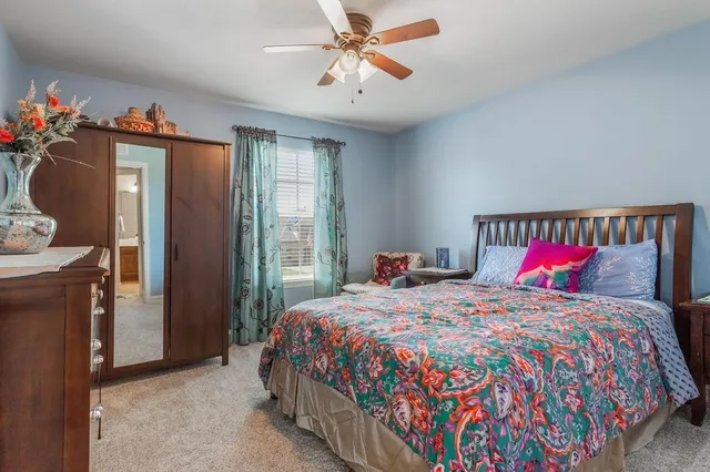 a bathroom with a sink a toilet a mirror a bathtub and shower