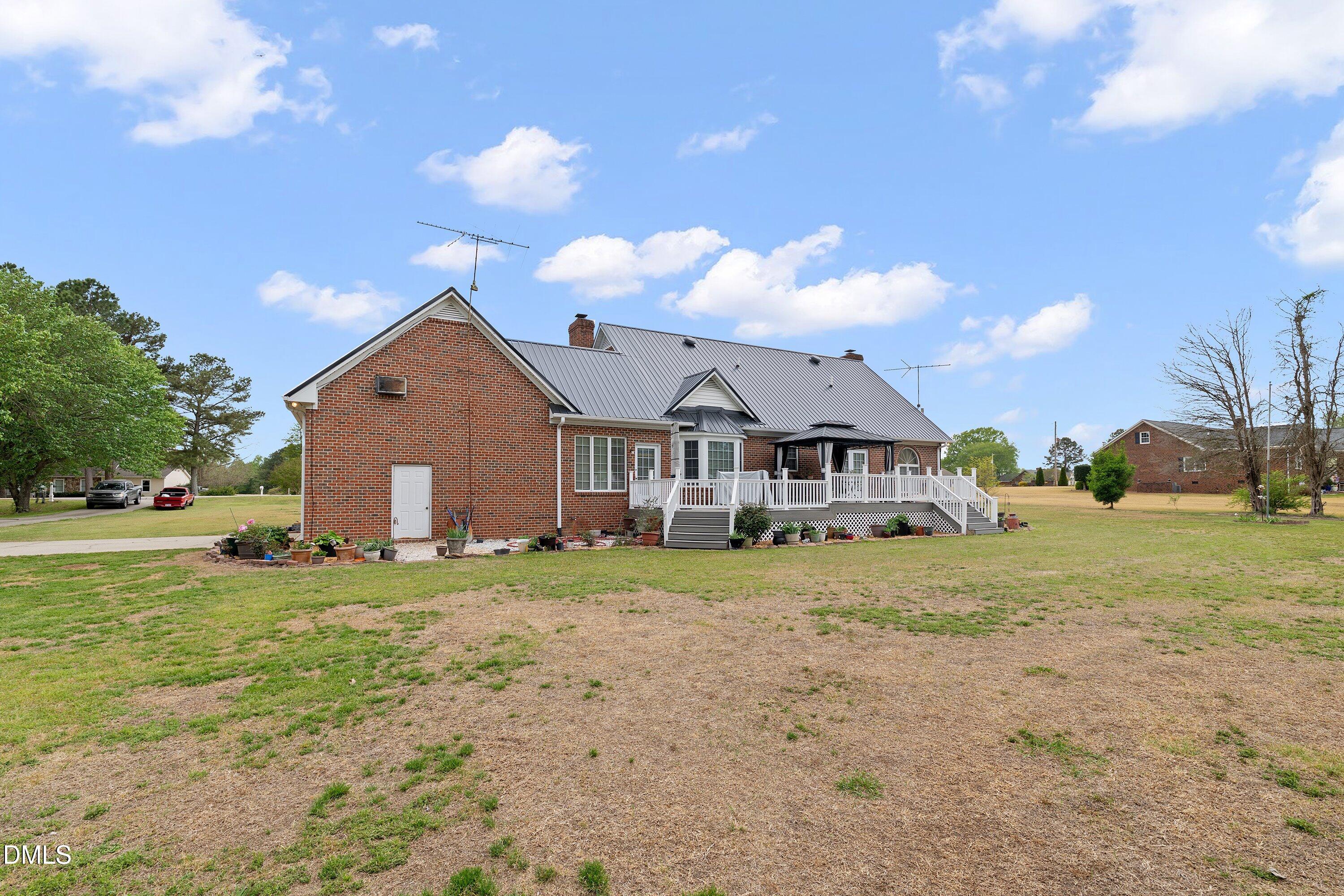 6314 Old Davis Road Sims, NC 27880 - Photo 52 of 71 a front view of a house with a yard and garage