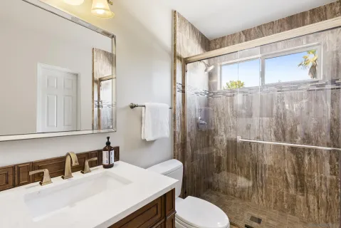 a bathroom with a sink toilet and shower