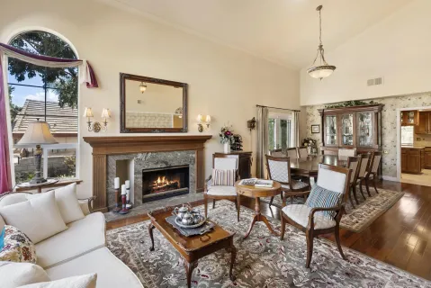 a living room with furniture a fireplace and a table