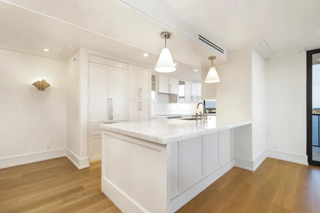 a kitchen with kitchen island a sink stainless steel appliances and cabinets