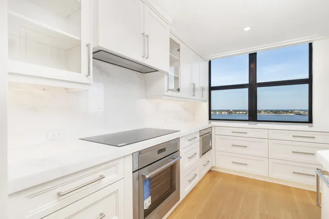 a kitchen with a stove and a white cabinet