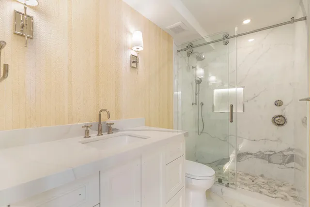 a bathroom with a sink toilet and shower