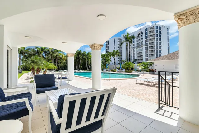 a view of a patio with couches table and chairs and potted plants