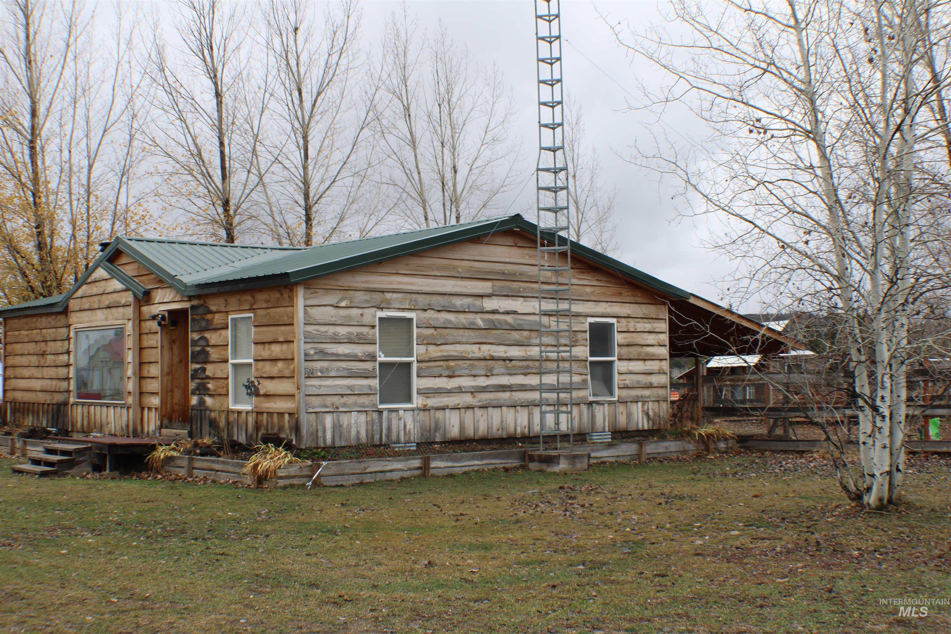 200 East Prairie Road Mountain Home, ID 83647 - Photo 2 of 38 View of property exterior featuring a lawn and a metal roof