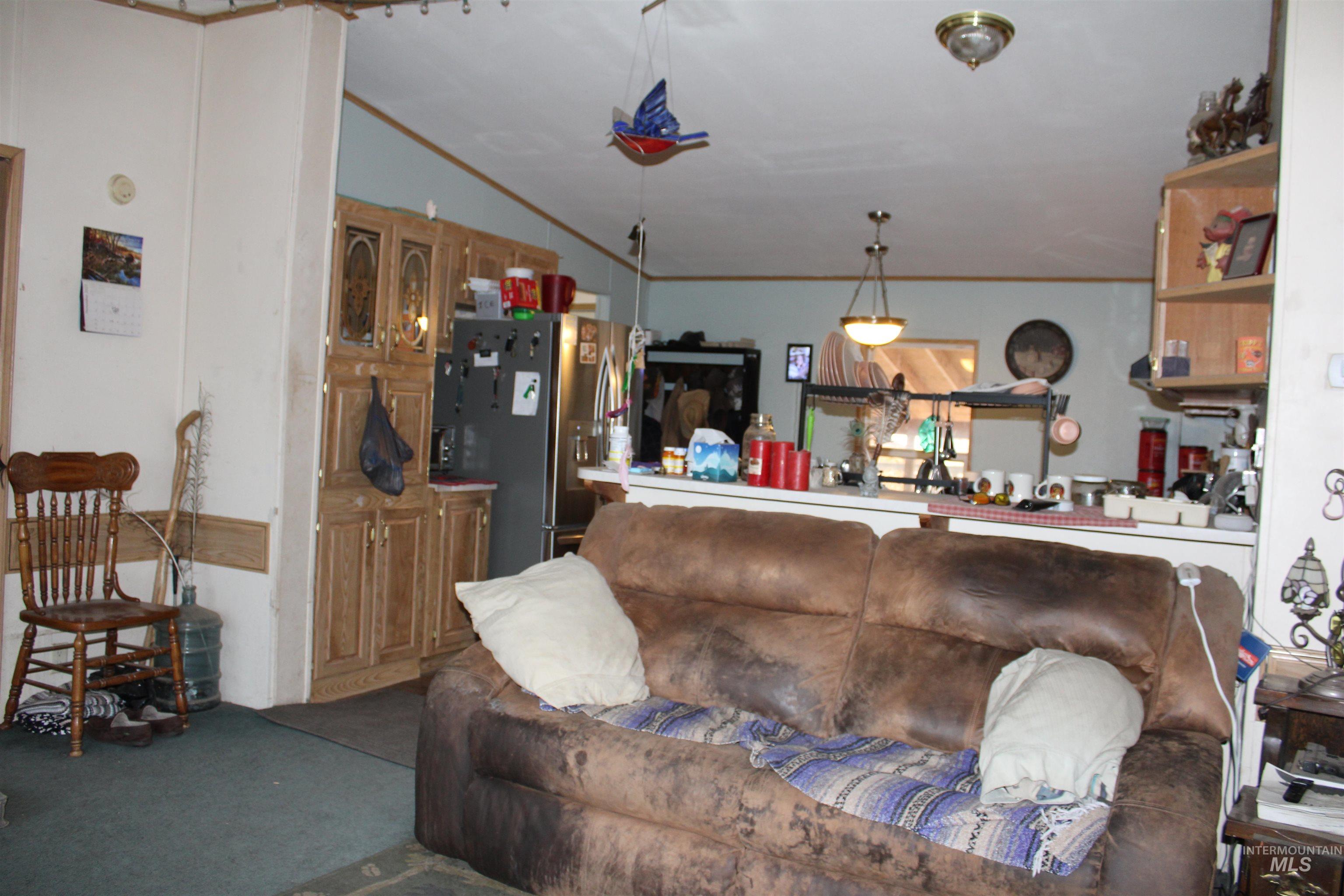 200 East Prairie Road Mountain Home, ID 83647 - Photo 21 of 38 Living area featuring ornamental molding and carpet floors