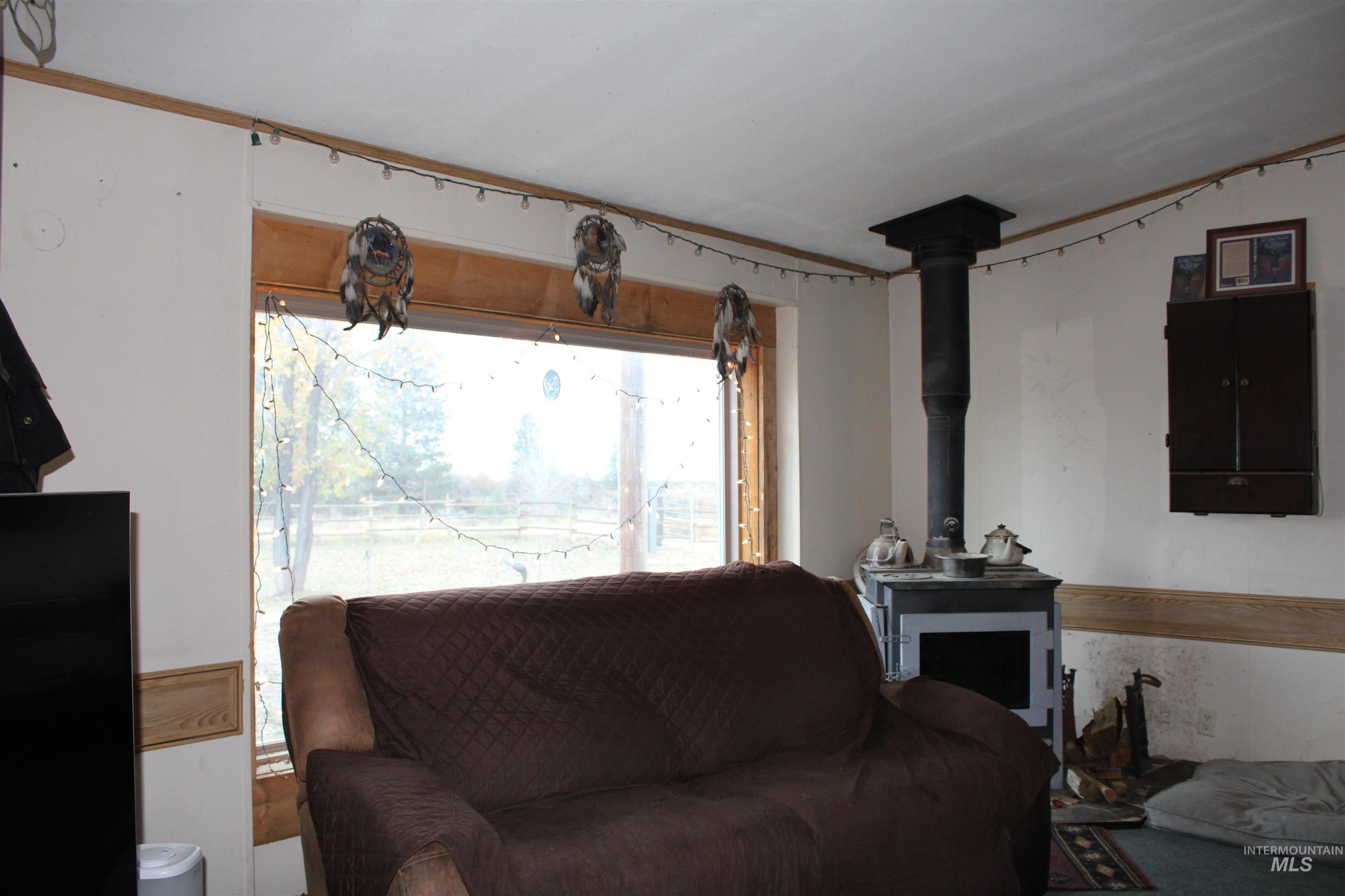 200 East Prairie Road Mountain Home, ID 83647 - Photo 22 of 38 Living area with a wood stove
