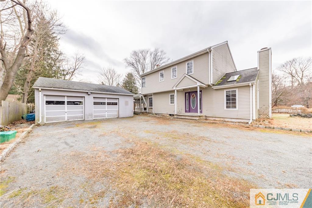 26 Moquis Trail Oak Ridge, NJ 07438 - Photo 2 of 23 a front view of a house with a yard covered in snow