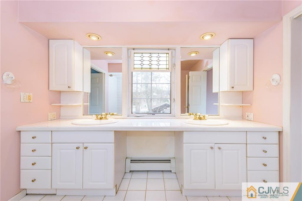 26 Moquis Trail Oak Ridge, NJ 07438 - Photo 21 of 23 a kitchen with white cabinets and sink