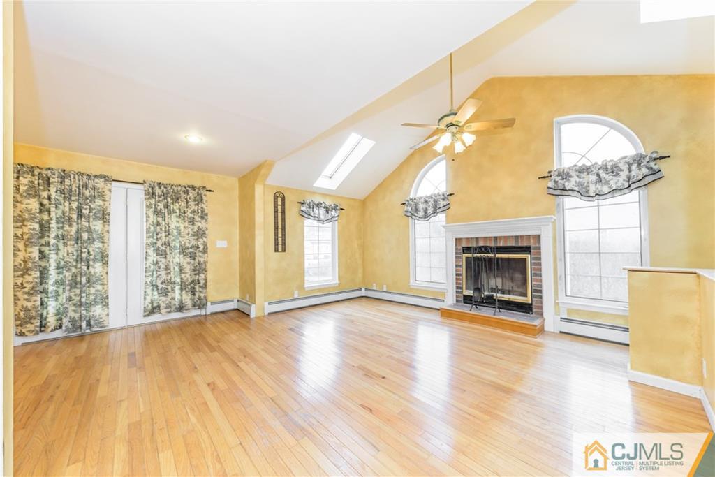 26 Moquis Trail Oak Ridge, NJ 07438 - Photo 6 of 23 a view of an empty room with a fireplace and a window