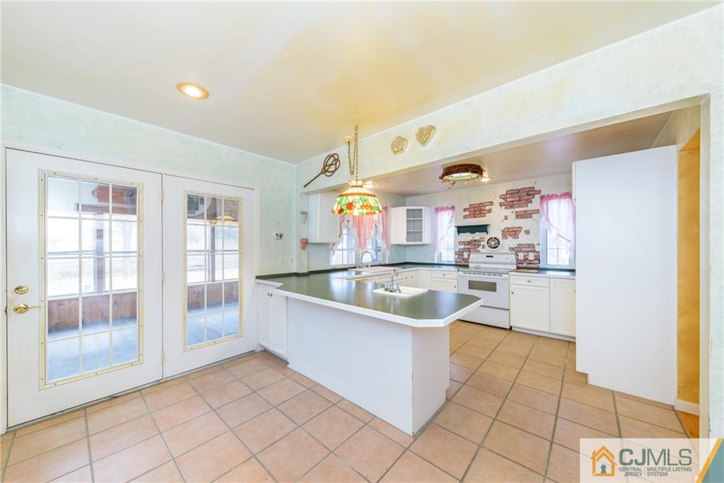 26 Moquis Trail Oak Ridge, NJ 07438 - Photo 9 of 23 a view of a kitchen with kitchen island stainless steel appliances refrigerator sink and cabinets